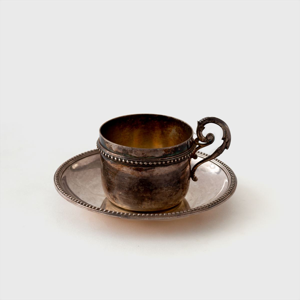 silver cup and saucer