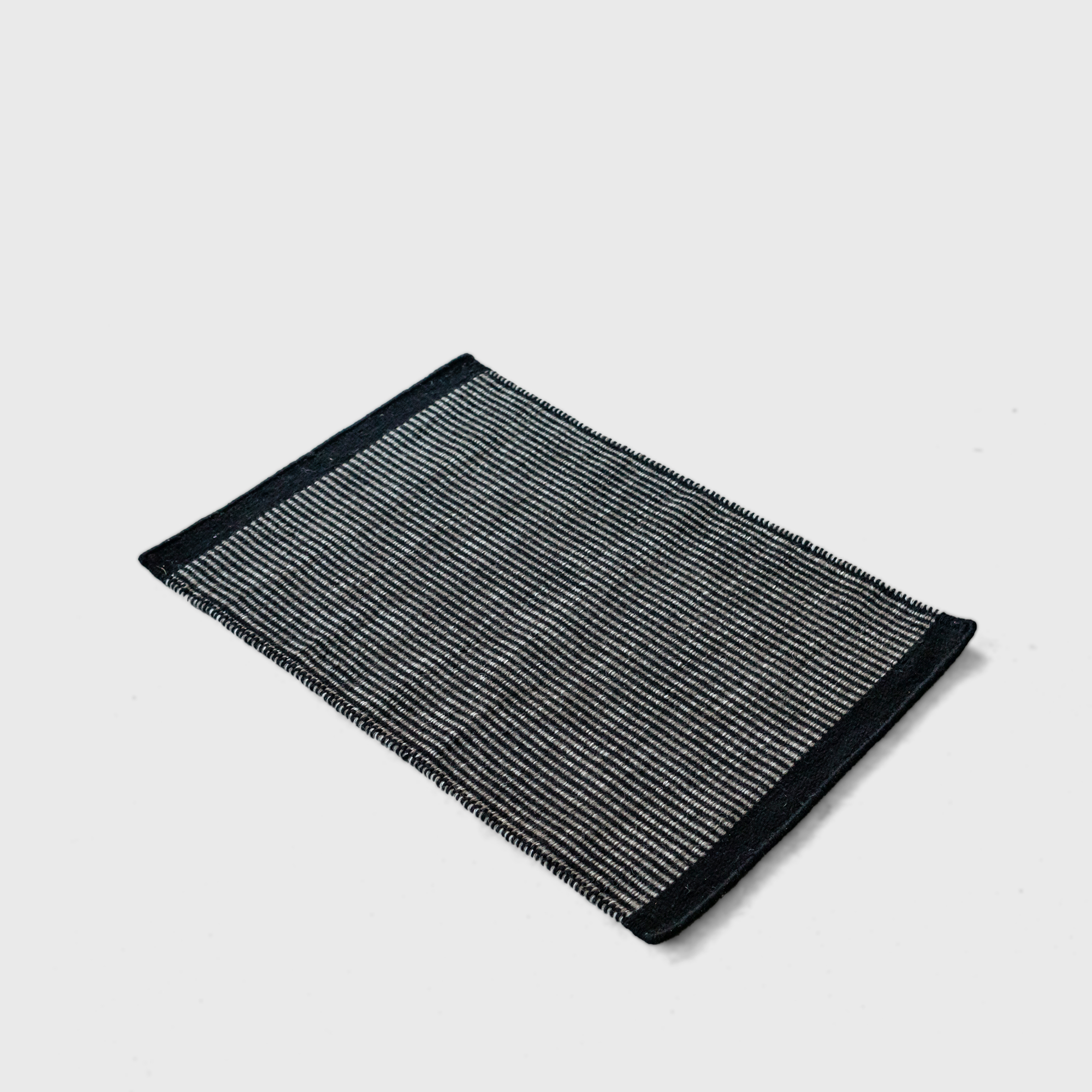 black plain weave rug