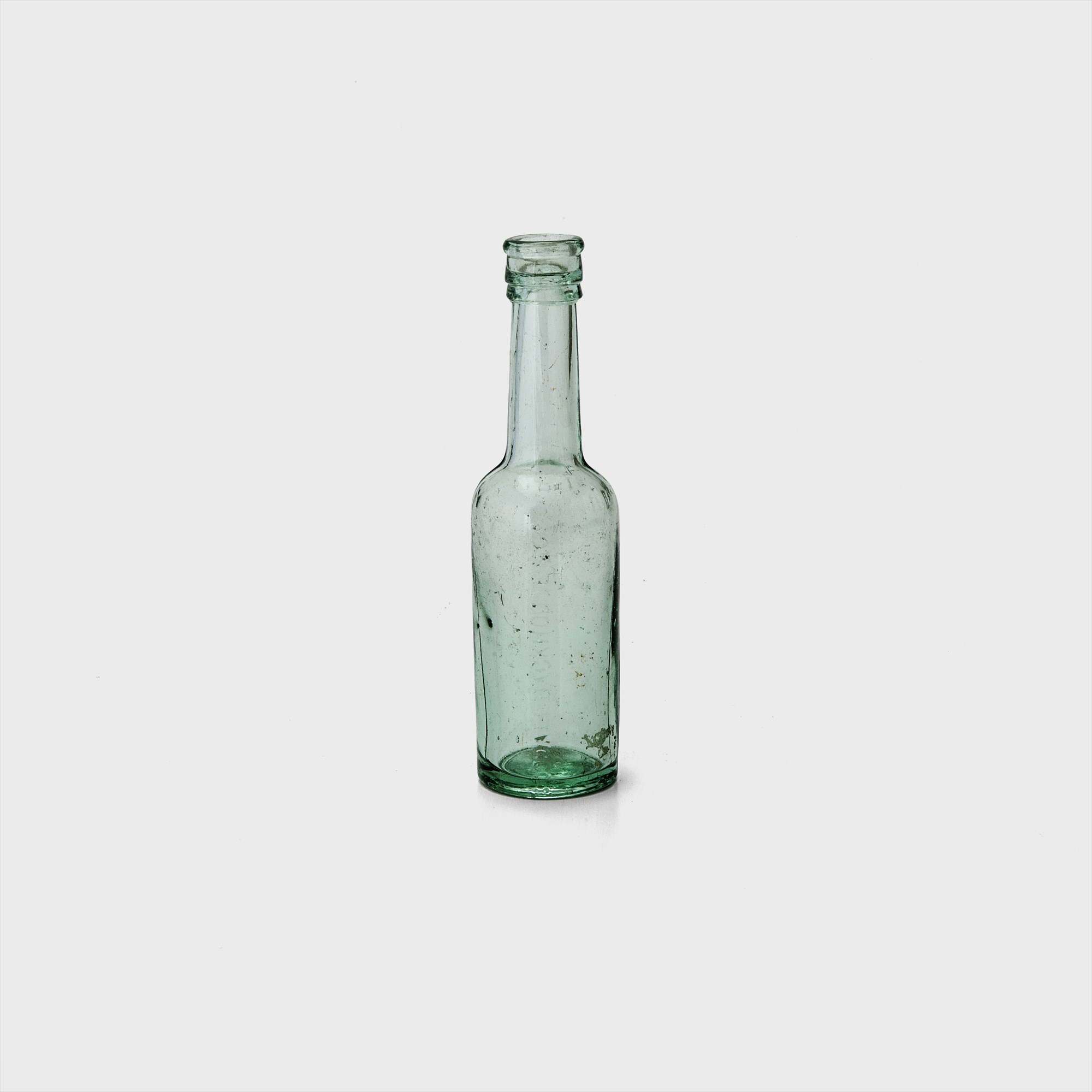 green clear glass bottle